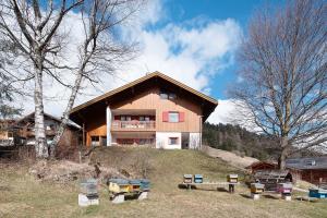 a house on a hill with benches in front of it at Agritur Ciasa Do Pare in Festilli