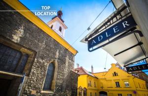 a street sign in front of a yellow building at Hotel Adler - Czech Leading Hotels in Prague