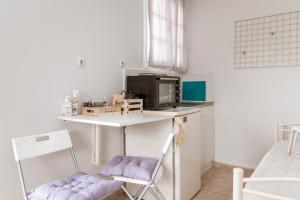 a small kitchen with a table and a microwave at Stenies Little Nook in Steniaí +15 photos