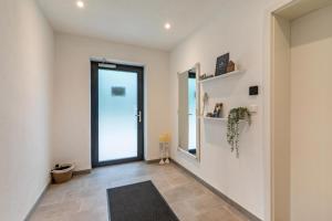 a hallway with a large glass door and a rug at Fewo Parkside S1 - 8Min Legoland in Günzburg