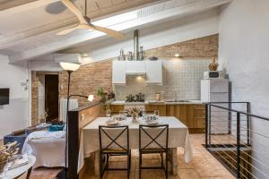 a kitchen with a table and chairs in a room at Mas Tarres L'acacia Only Adults in Madremanya