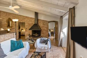 a living room with a couch and a fireplace at Mas Tarres L'acacia Only Adults in Madremanya