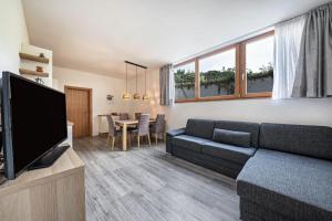 a living room with a couch and a tv at Ferienwohnung Golserhof in Merano