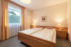 a bedroom with a large bed and a large window at Ferienwohnung 2 Vikoler in Vols am Schlern