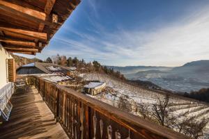 a balcony with a view of a snow covered mountain at Malgorerhof Sonja in San Genesio Atesino