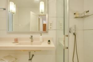 ein weißes Badezimmer mit Waschbecken und Dusche in der Unterkunft Fantástico Apartamento cerca Playa in Las Palmas de Gran Canaria + 15 Fotos