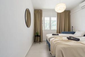a bedroom with two beds and a mirror at Modern villa with private pool in Mijas +15 photos