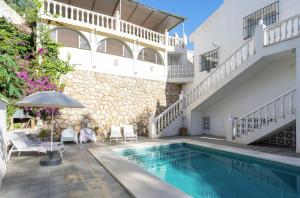 a villa with a swimming pool and a house at Modern villa with private pool in Mijas