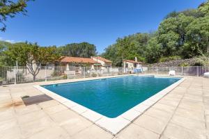a swimming pool in a yard with a fence at Gite 3 entre 2 et 4 personne in Reynès