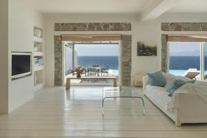 a living room with a couch and a view of the ocean at Villa Coventina in Agios Ioannis Mykonos