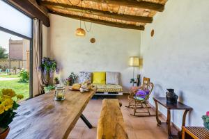 a living room with a wooden table and a couch at Castell del Montgrí Rural in Torroella de Montgrí