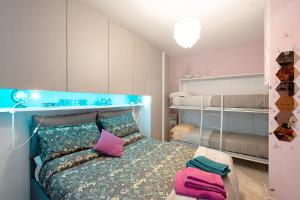 a bedroom with a bed with a blue head board at Zena in Genova