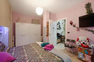 a bedroom with a bed and a tv in a room at Zena in Genova