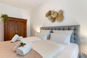 a bedroom with two beds with towels and hats on the wall at Km Style Apartments 4 in Freiburg im Breisgau
