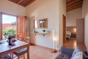 a living room with a table and a couch at Casa Quemahierro 1 in Icod de los Vinos