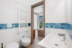 a white bathroom with a sink and a toilet at Ce Tour - Cetara Guest House in Cetara