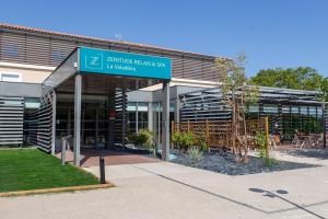 a building with a street sign in front of it at Zenitude Hotel La Valadière, Ascend Hotel Collection in Montpellier +152 photos