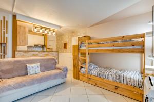 a living room with two bunk beds and a couch at Sunshine in La Grande-Motte