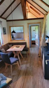a living room with a wooden table and chairs at Bienenhaus in Dornhan