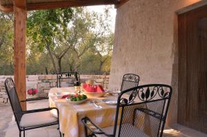 a table with a bowl of fruit on a patio at Lamia Pieranna in Cisternino