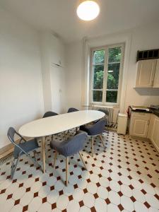 a kitchen with a table and chairs in a room at Villa Isabelle in Allevard +10 photos