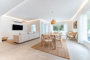 a living room with a table and a couch at Villa Lemac in La Cala de Mijas