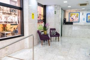 a lobby with two chairs and a table at Hotel Faranda Pathos Gijón, Ascend Hotel Collection in Gijón