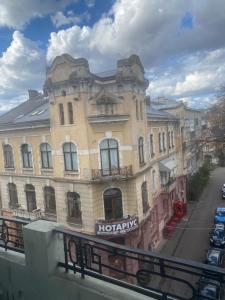 a large building on the side of a street at Old city apart in Ivano-Frankivsʼk