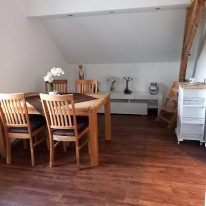 a dining room with a wooden table and chairs at Hartmannshof in Hau +14 photos