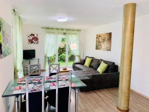 a living room with a couch and a table at H N H Ferienwohnung in Lindau