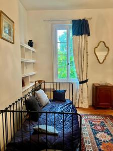 a bedroom with a bed and a window at Château Le Baudou in Coutras