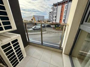 a balcony with a view of a city street at Urban Glow Next to Hospital by Cosher in Bŭnzareto