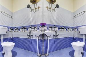 a bathroom with two sinks and two toilets at Super Hotel O Indian Residency, Near Adams Academy, Kadugodi in Bengaluru
