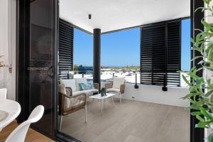 an open living room with a view of the airport at Bokarina Beach Apartments, an Ascend Collection Hotel in Bokarina