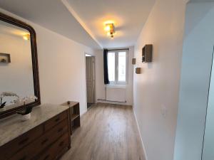 a bathroom with a vanity and a mirror and a window at Les petits gaillards in Les Andelys +3 photos