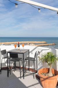 a table and chairs on a patio overlooking the ocean at Seaview Apartment N12 in El Perelló