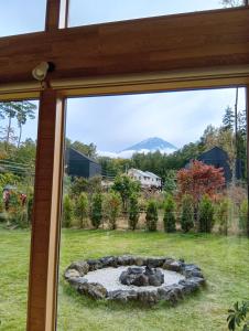 a window view of a yard with a fire pit at Villa 峰々 in Fujikawaguchiko