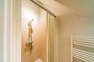a shower with a glass door in a bathroom at Le Céleste - Parking Privatif - Terrasse - Netflix in Ballan-Miré +27 photos