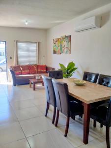 a living room with a wooden table and chairs at DOLPHIN Maeva Residencial in Puerto Peñasco