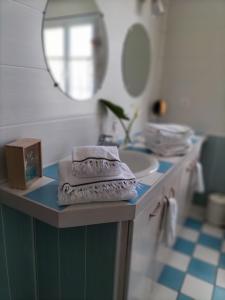 a bathroom with a counter with a sink and a mirror at LUCIA AL MARE - chambre d'hôtes in Châtelaillon-Plage