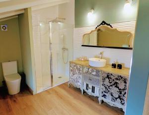 a bathroom with a sink and a shower and a toilet at Loft el Pasaje Secreto in Solórzano +9 photos