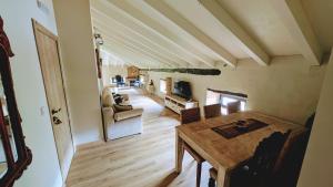 a living room with a wooden table and a dining room at Loft el Pasaje Secreto in Solórzano