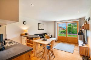 a kitchen with a table and a dining room at Ferienwohnung Nordic -Reit im Winkl in Reit im Winkl