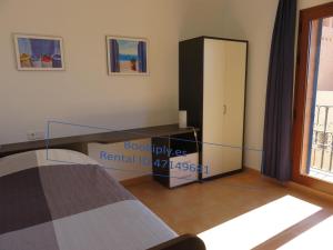 a bedroom with a bed and a sliding glass door at Kasbah del Puerto Rey Apuesto Ático in Playas de Vera