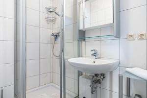 a bathroom with a sink and a shower at Fewo am Hochufer - erste Reihe in Ostseebad Sellin +22 photos