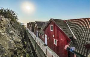 a row of red houses next to a wall at Nice Apartment In Korshamn With House Sea View in Korshamn
