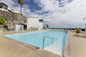 a large swimming pool in the middle of a building at Bungalow Josephin in Patalavaca