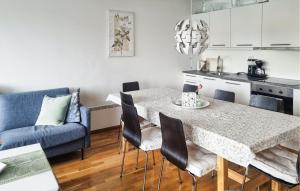 a kitchen and dining room with a table and chairs at Nice Apartment In Korshamn With House Sea View in Korshamn