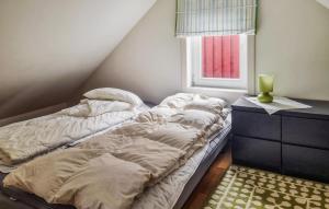 a bedroom with two unmade beds and a window at Nice Apartment In Korshamn With House Sea View in Korshamn