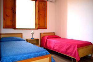 Ένα ή περισσότερα κρεβάτια σε δωμάτιο στο Ll52 Casa vacanze Taki